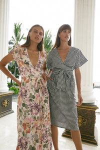 Closer view of two women modelling wearing summer midi dresses