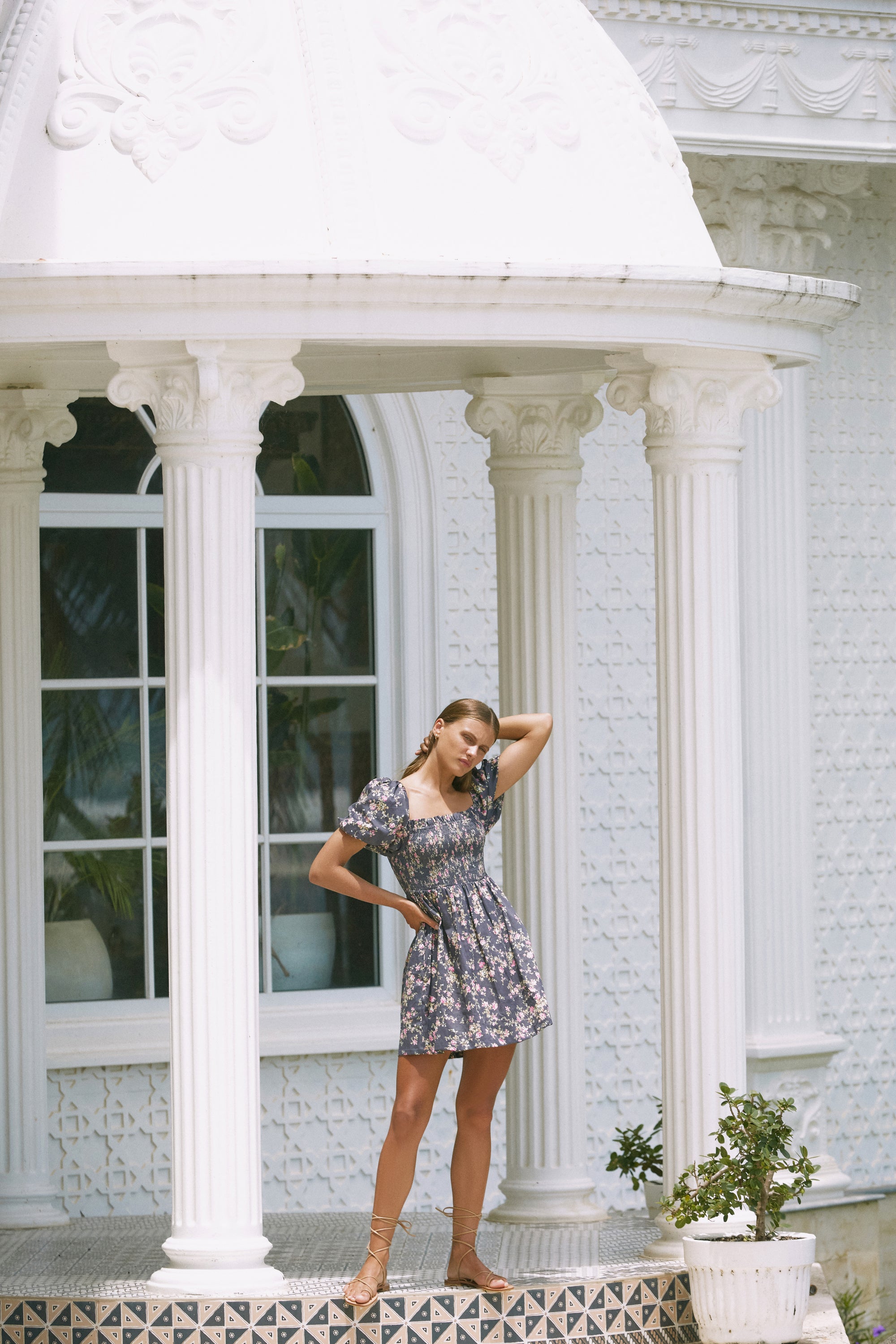 Woman modelling in front of a porch wearing floral print summer dress