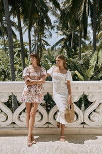 Two women modelling wearing floral printed casual summer dress and heels