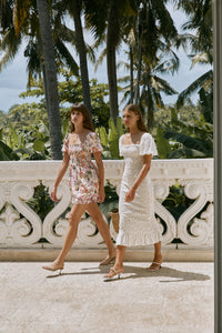 Two women wearing floral printed casual summer dress and heels