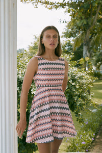 Woman in a birken stripe dress standing on a porch