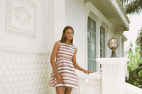 Woman in a birken stripe dress modelling on a porch