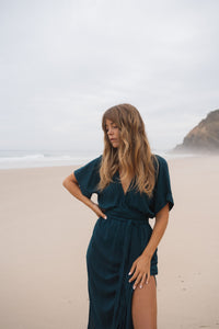 Girl on beach wearing teal dress