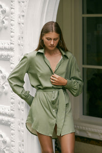 Woman wearing silky-feel olive green shirt dress