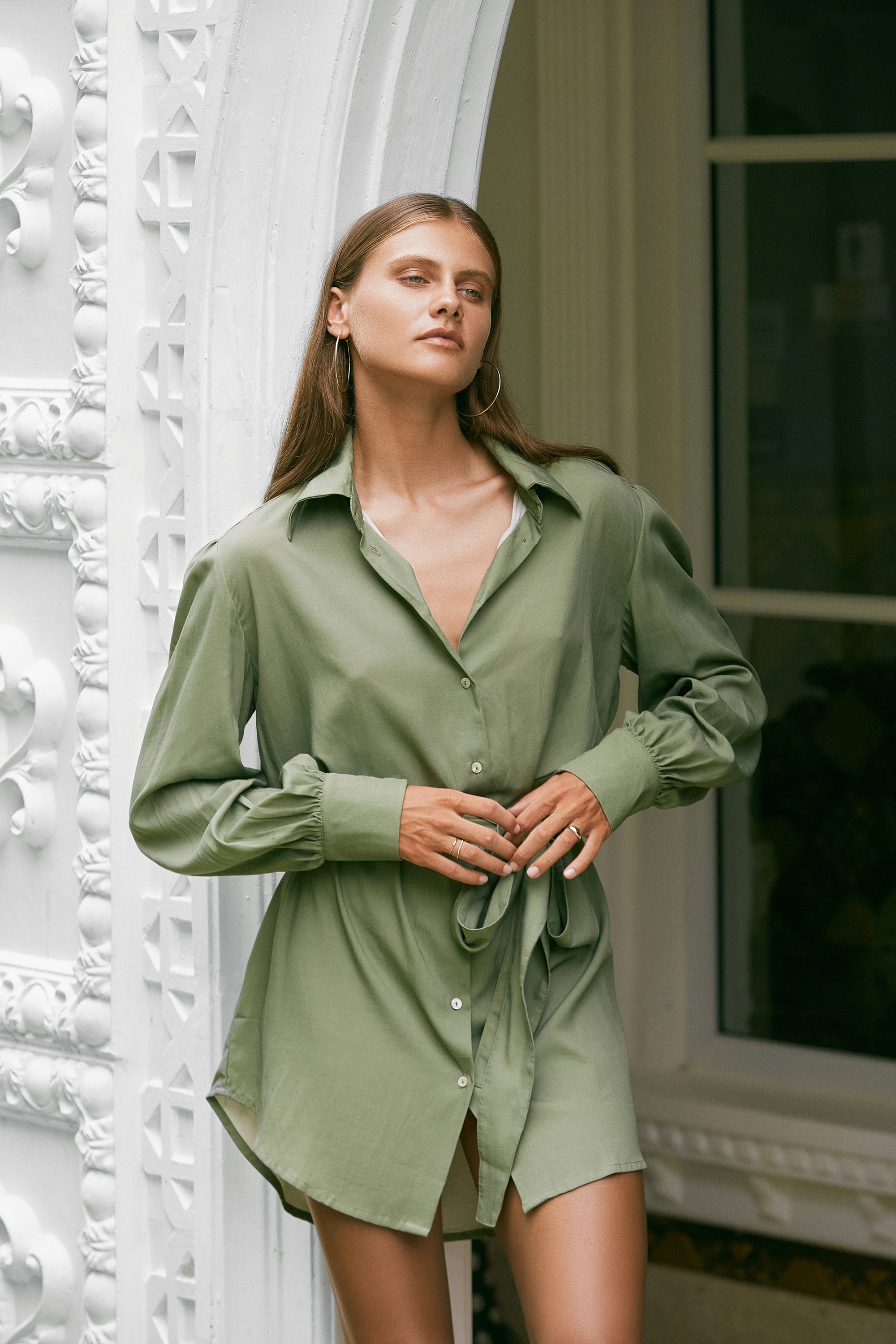 Woman modelling wearing silky-feel olive green shirt dress